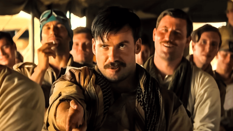 Connor Swindells as Lieutenant David Stirling holding out his hand in Rogue Heroes