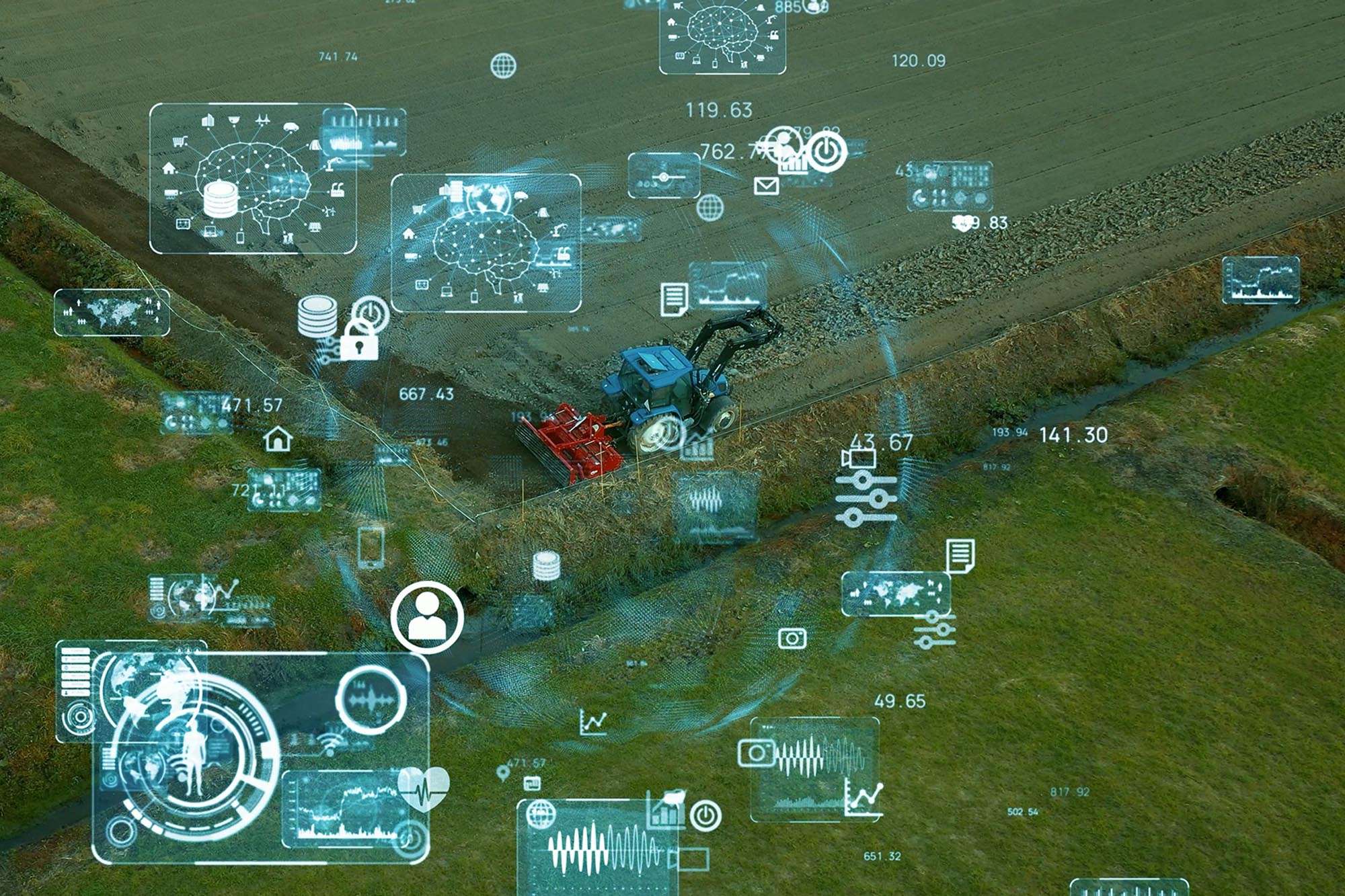 A tractor working a field with a computerized image on top.